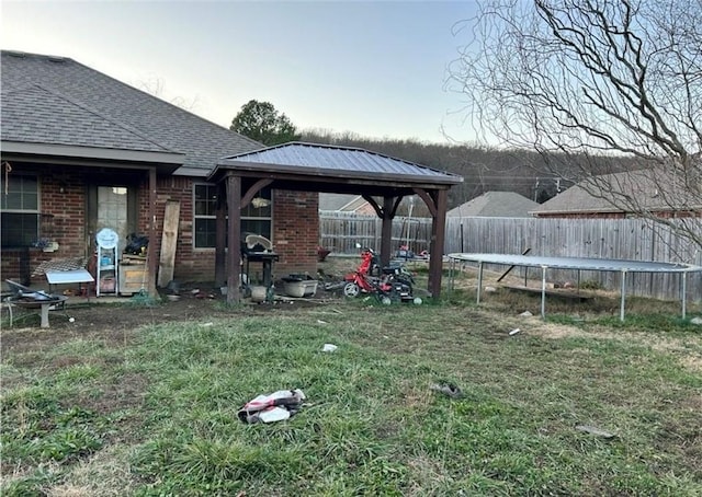 view of yard featuring a gazebo and a trampoline