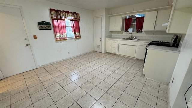 kitchen with ventilation hood, white cabinetry, range, and sink