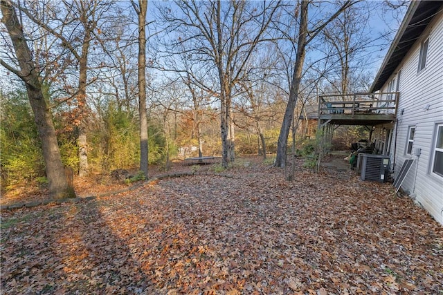 view of yard featuring central AC and a deck