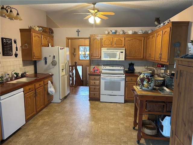 kitchen with decorative backsplash, ceiling fan, white appliances, and sink