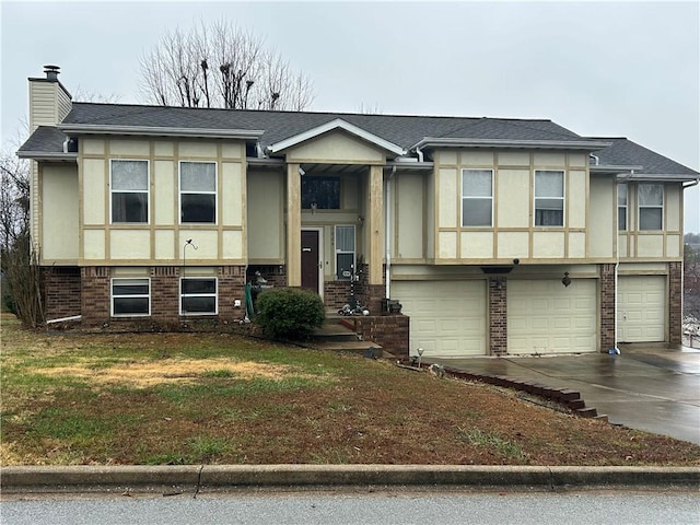 view of front of home with a front yard and a garage