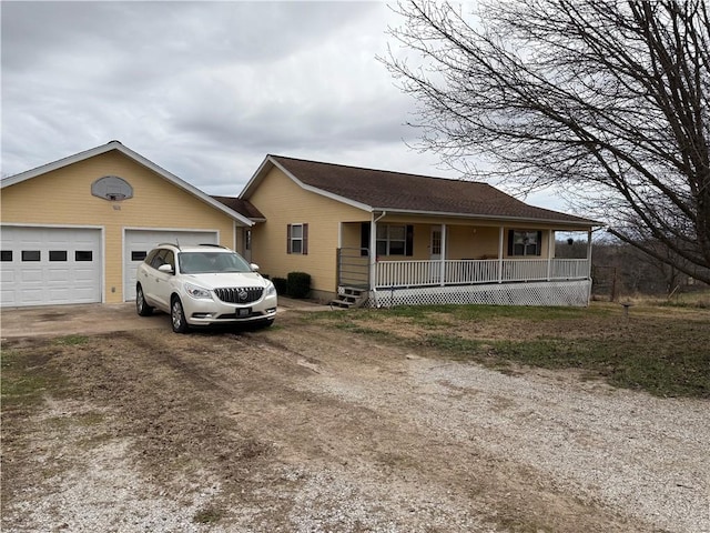 ranch-style home with a garage and covered porch