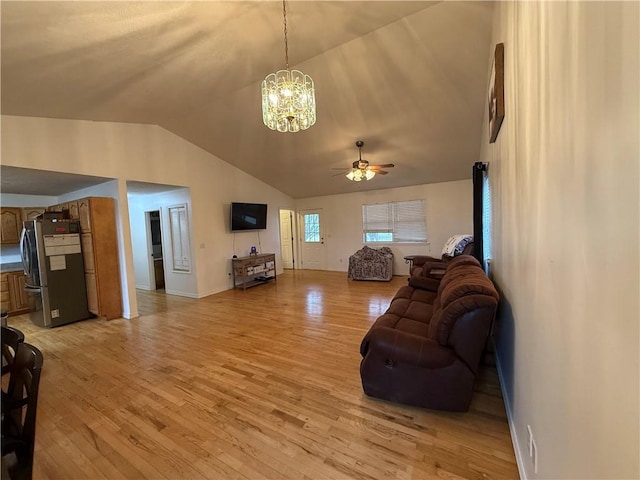 living room featuring ceiling fan with notable chandelier, lofted ceiling, and light hardwood / wood-style flooring