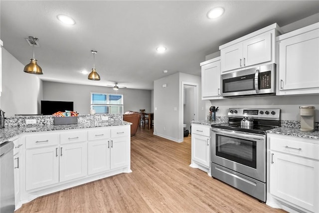 kitchen featuring pendant lighting, white cabinets, light hardwood / wood-style flooring, ceiling fan, and stainless steel appliances