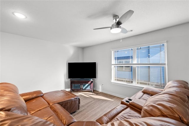 living room with light wood-type flooring and ceiling fan