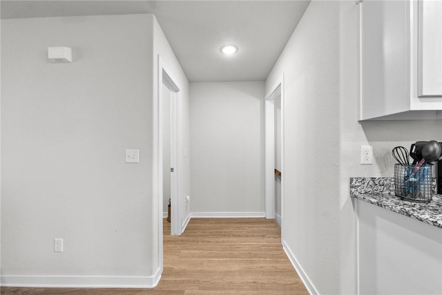 hallway with light wood-type flooring