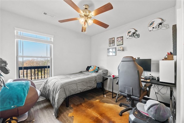 bedroom featuring ceiling fan and dark hardwood / wood-style floors