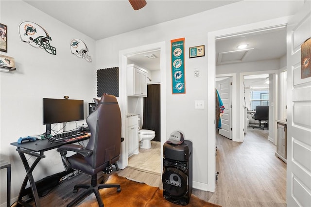 office space with ceiling fan and light hardwood / wood-style flooring