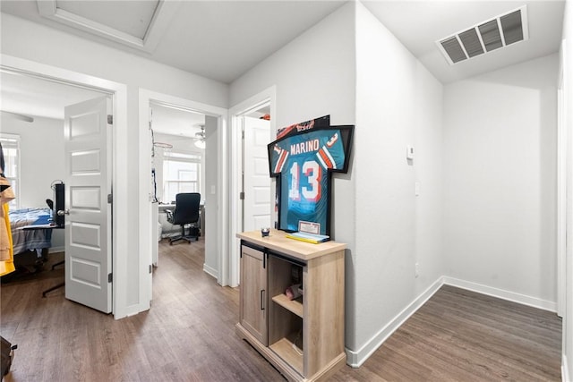 hallway with dark hardwood / wood-style flooring