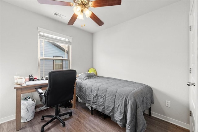 bedroom with dark hardwood / wood-style flooring and ceiling fan