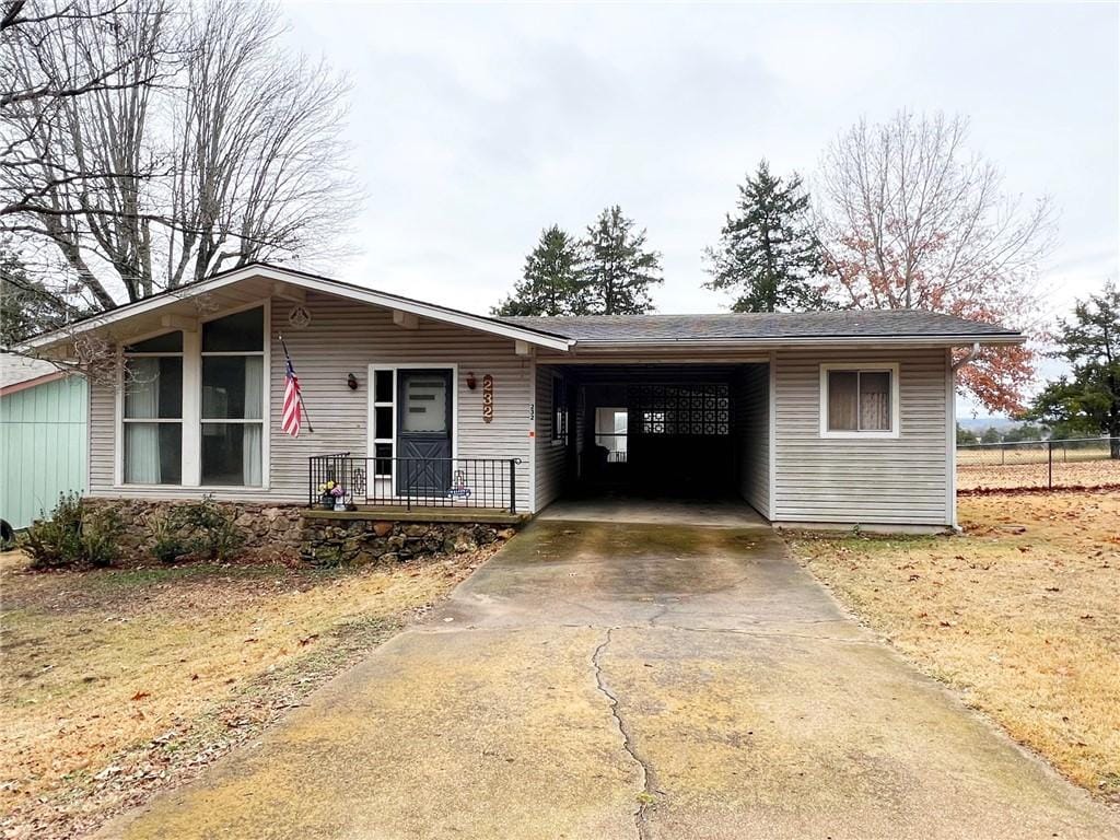 ranch-style house featuring a carport