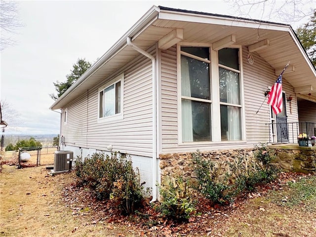 view of side of home featuring central AC unit