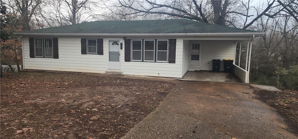 ranch-style house featuring a carport