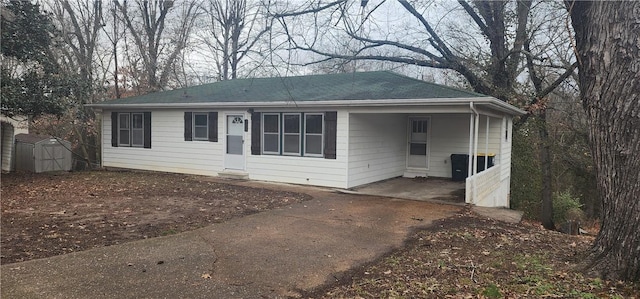 view of front facade with a carport and a shed