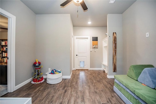 sitting room with wood-type flooring and ceiling fan