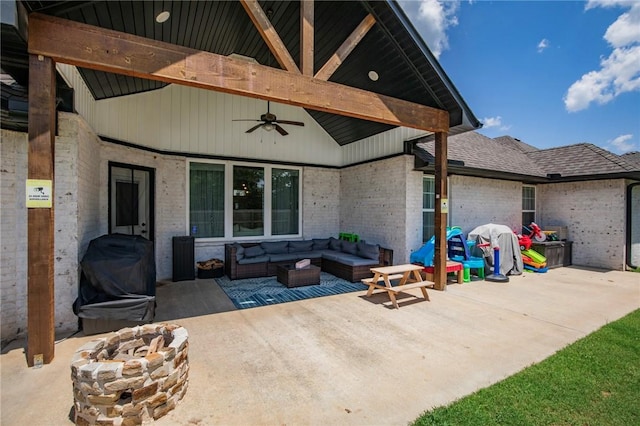 view of patio / terrace featuring ceiling fan and an outdoor living space with a fire pit