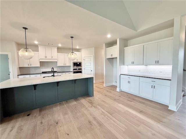 kitchen featuring white cabinetry, baseboards, appliances with stainless steel finishes, decorative backsplash, and recessed lighting
