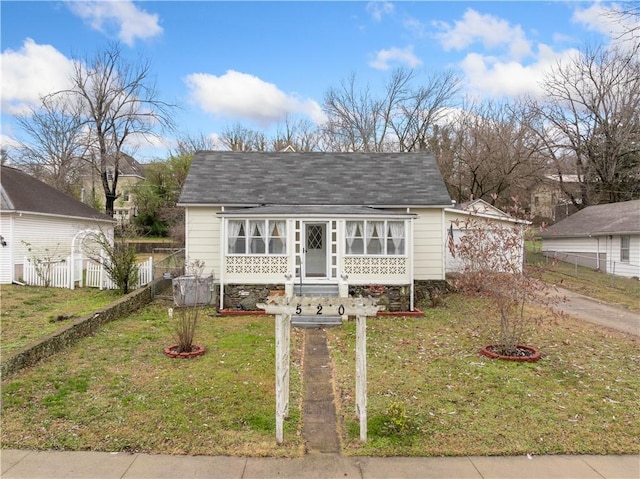 bungalow-style house featuring a front yard