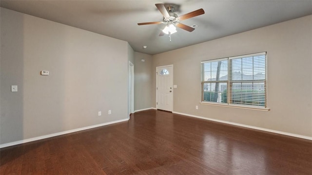 unfurnished room with ceiling fan and dark wood-type flooring