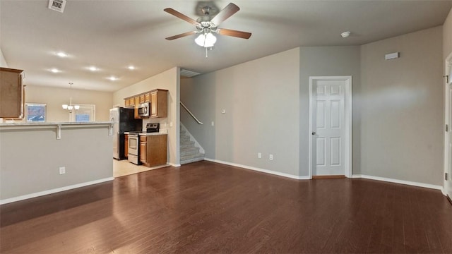 unfurnished living room featuring ceiling fan with notable chandelier and light hardwood / wood-style flooring