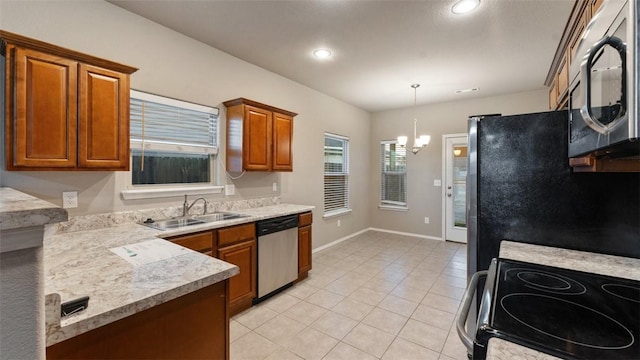 kitchen with sink, an inviting chandelier, pendant lighting, light tile patterned flooring, and appliances with stainless steel finishes