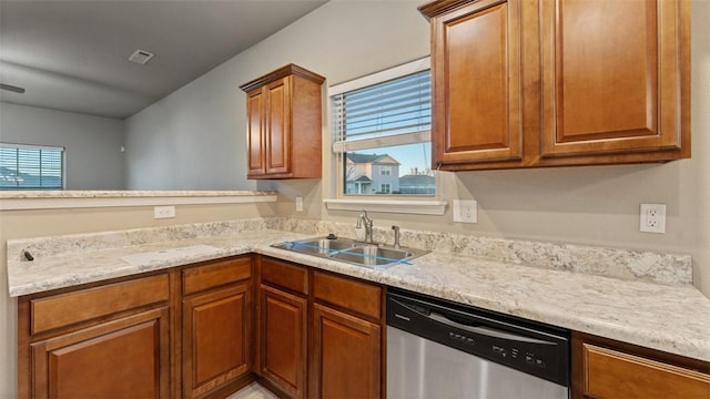 kitchen with a wealth of natural light, dishwasher, and sink