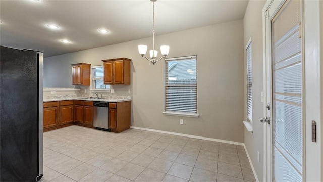 kitchen with decorative light fixtures, appliances with stainless steel finishes, a notable chandelier, light tile patterned flooring, and light stone counters