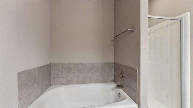 bathroom with a tub to relax in