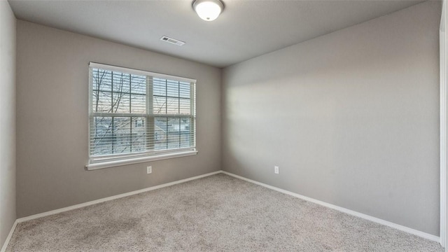 empty room featuring light carpet