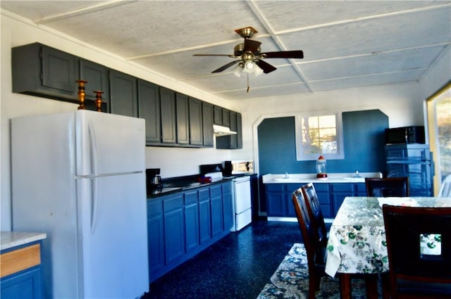 kitchen featuring blue cabinetry, white appliances, and ceiling fan