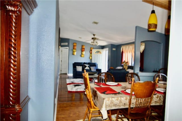 dining area with dark hardwood / wood-style flooring, vaulted ceiling, and ceiling fan