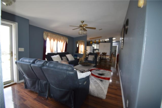 living room featuring ceiling fan, plenty of natural light, and dark hardwood / wood-style floors