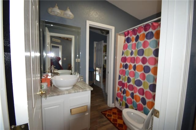 bathroom with hardwood / wood-style floors, vanity, and a shower with curtain