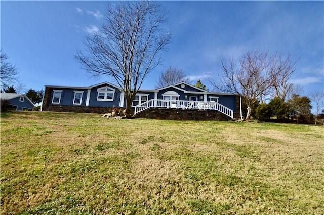 view of front of property featuring a front lawn and a wooden deck