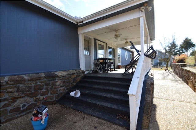 entrance to property with a porch and ceiling fan