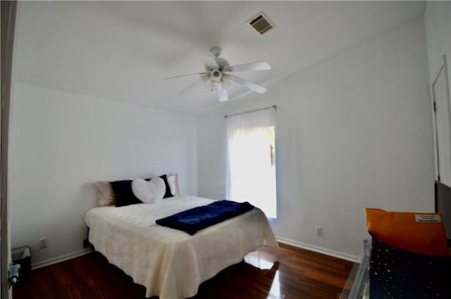 bedroom with ceiling fan and dark hardwood / wood-style floors