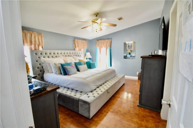 bedroom featuring ceiling fan, wood-type flooring, and vaulted ceiling