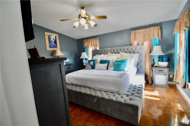 bedroom featuring ceiling fan and dark wood-type flooring