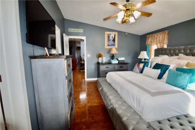 bedroom with dark hardwood / wood-style floors, ceiling fan, and lofted ceiling