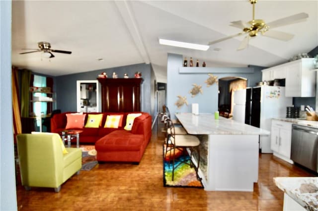 kitchen featuring dishwasher, a kitchen island, vaulted ceiling with beams, white refrigerator, and white cabinets