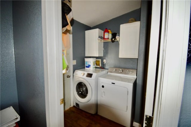 washroom featuring cabinets, washing machine and dryer, and dark hardwood / wood-style floors