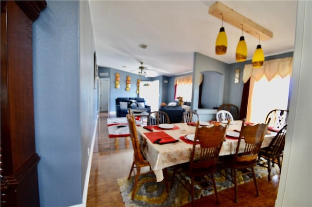 dining room featuring ceiling fan and dark wood-type flooring