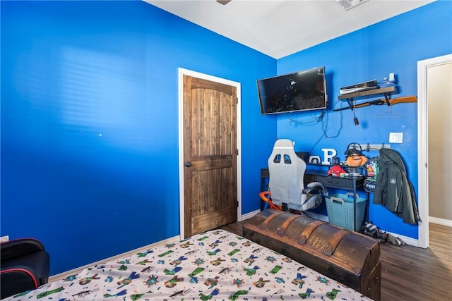 bedroom with hardwood / wood-style floors