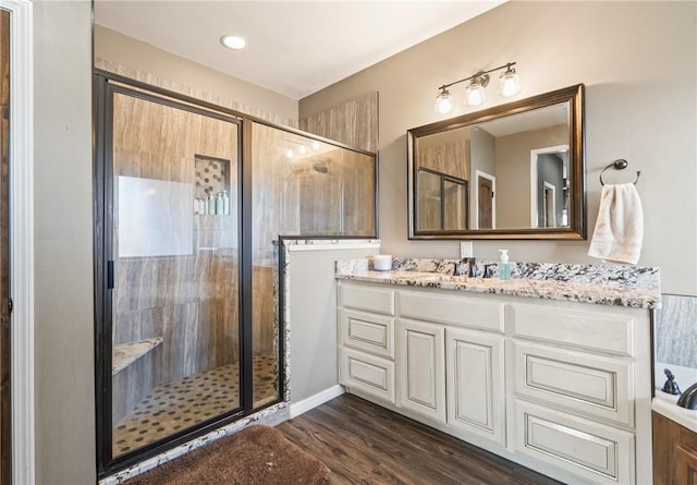 bathroom featuring vanity, hardwood / wood-style flooring, and an enclosed shower