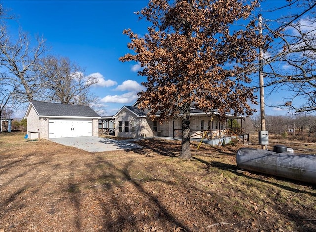 472899 640th Rd, Watts, OK 74964 - view of front of home featuring driveway, brick siding, and a garage