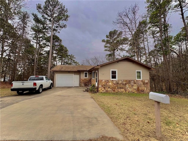 view of front of property featuring a garage and a front lawn