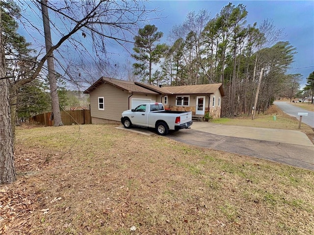 view of front of home with a garage and a front yard