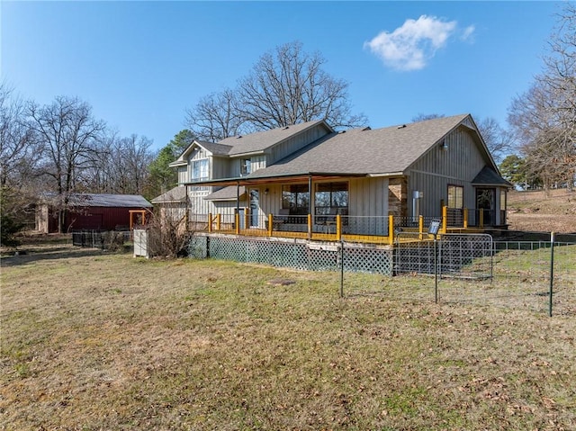 back of house with a lawn