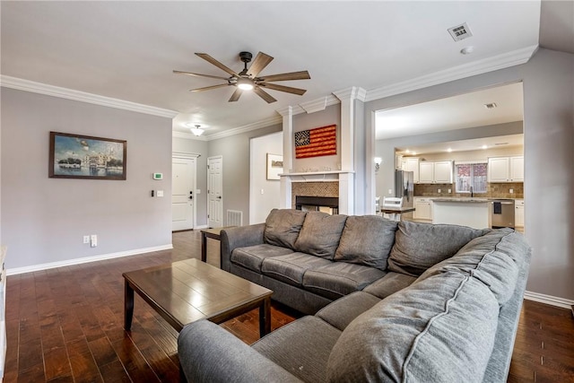 living room featuring ceiling fan, dark hardwood / wood-style flooring, and ornamental molding