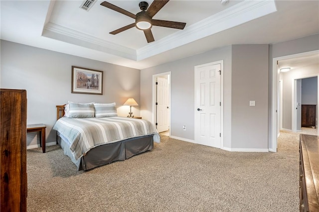 carpeted bedroom featuring a raised ceiling, ceiling fan, and ornamental molding